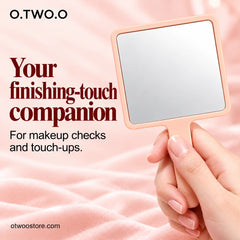 Compact peach handheld mirror used for makeup checks and quick touch-ups
