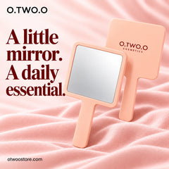 Peach handheld makeup mirror showing front and branded back on blush satin