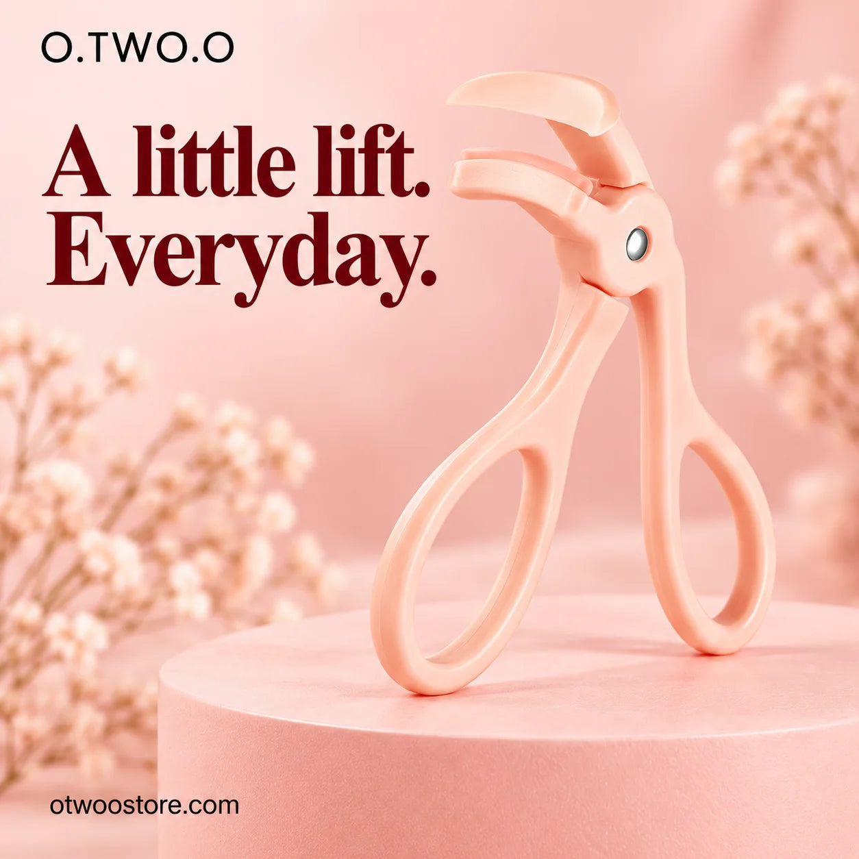 Peach 3D eyelash curler displayed upright on a soft blush pedestal