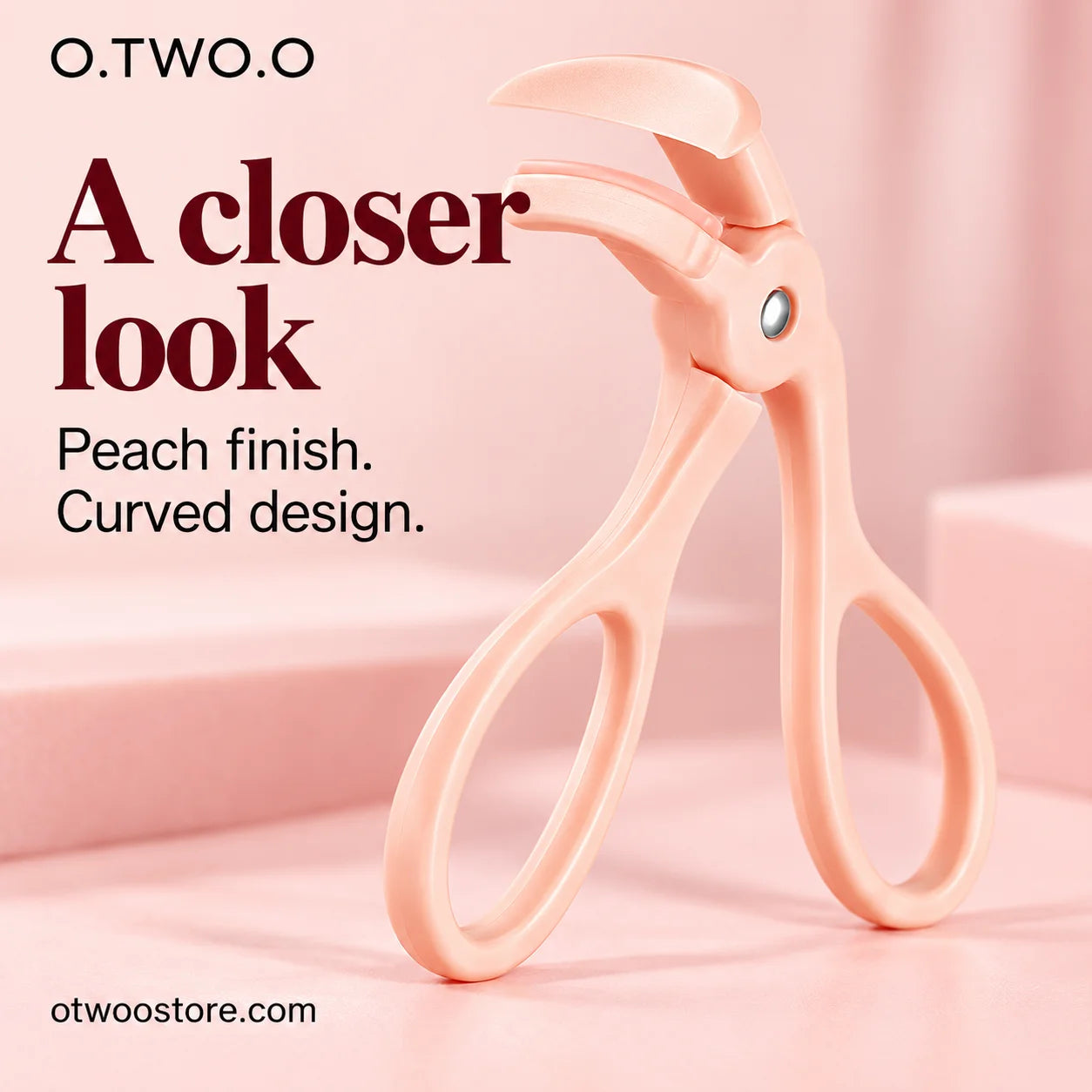 Close-up of peach-finish eyelash curler with smooth curved construction